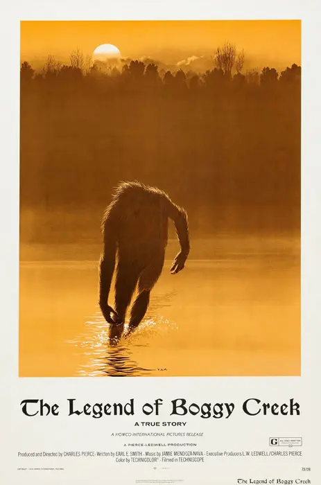 A man walking in the water with his feet up.