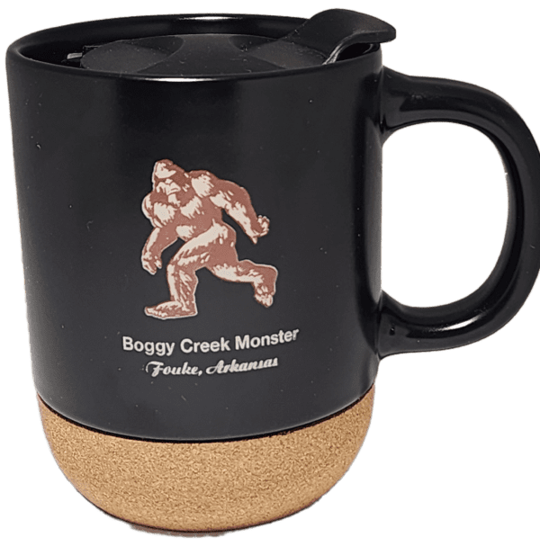 A black mug with a picture of a bigfoot on it.