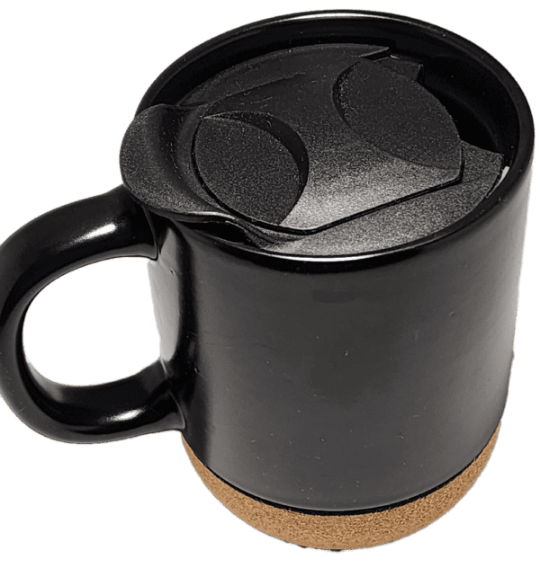 A black coffee mug with a lid on top of it.