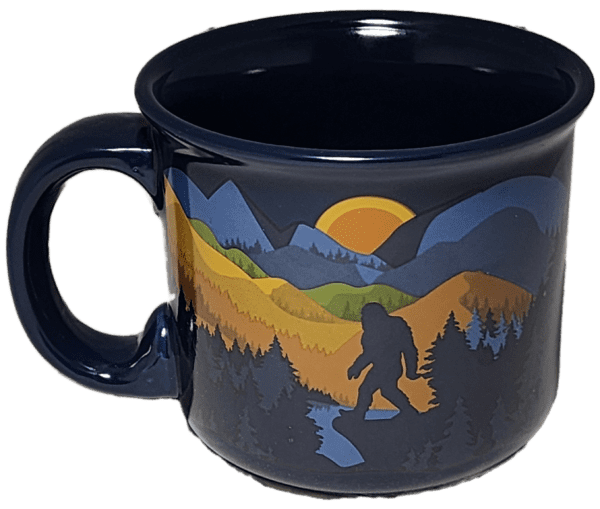 A black coffee cup with a picture of a bigfoot.