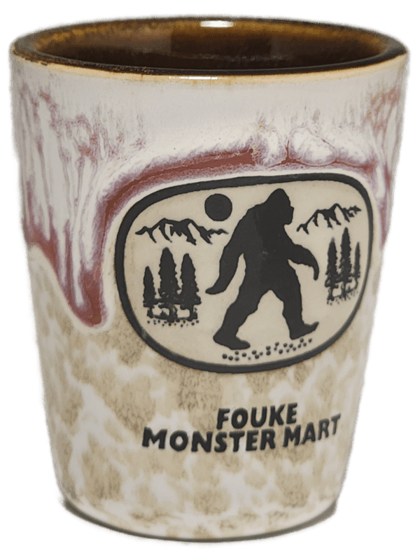 A cup with a picture of bigfoot on it.