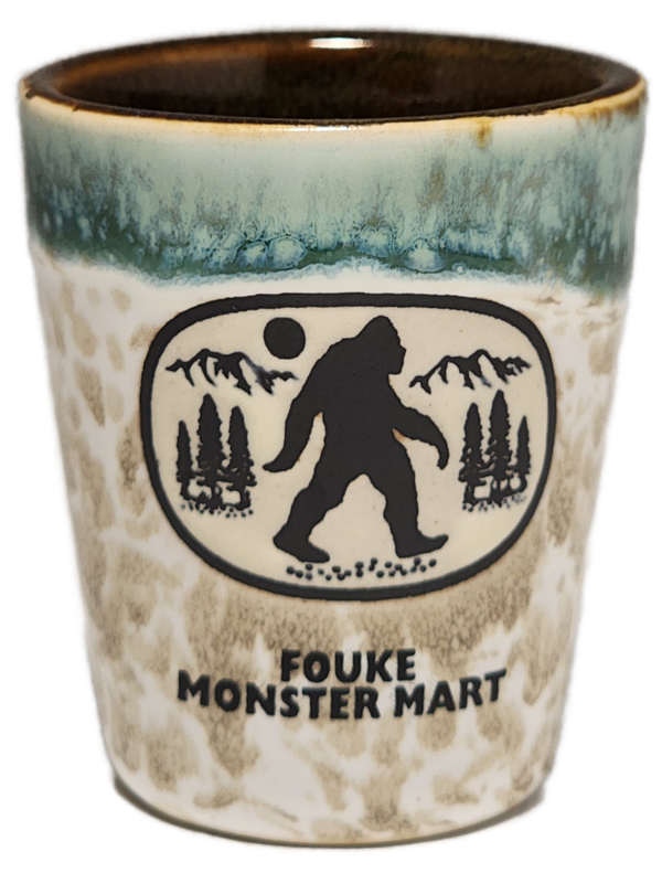 A cup with a picture of bigfoot on it.