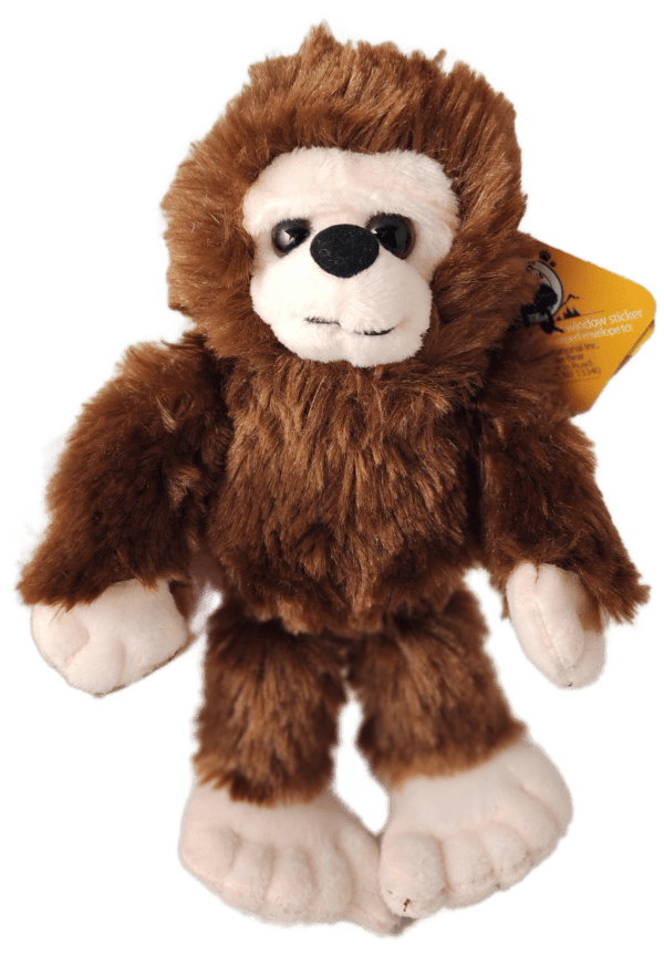 A stuffed animal monkey with a yellow tag.