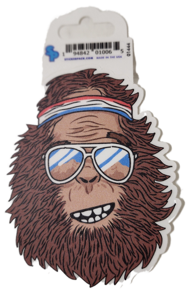 A sticker of a bigfoot wearing sunglasses and a headband.