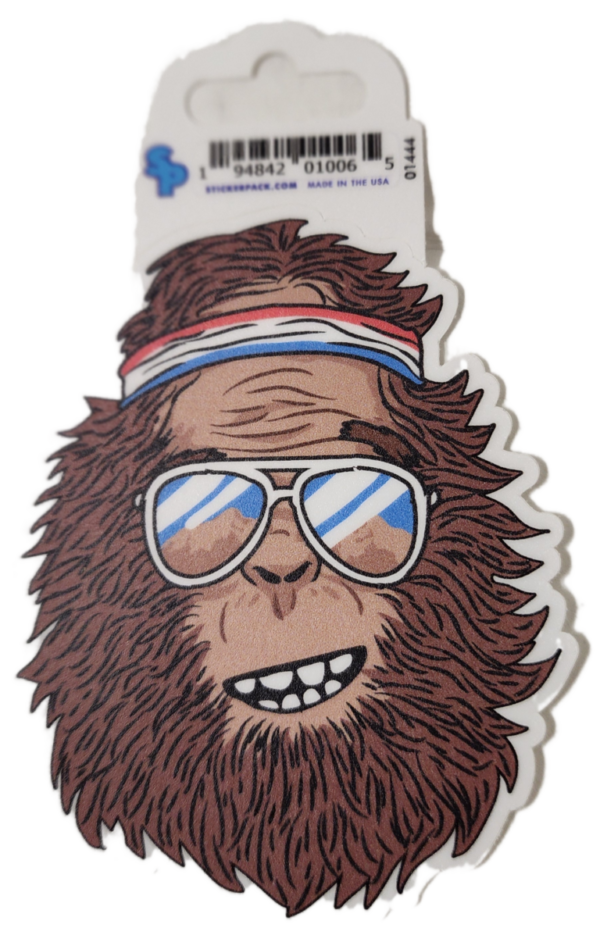 A sticker of a bigfoot wearing sunglasses and a headband.