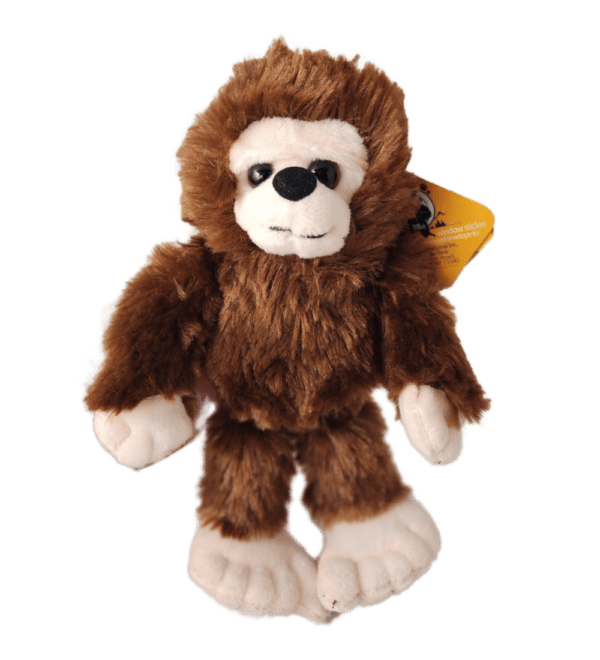 A stuffed animal is wearing a brown and white outfit.