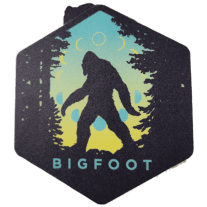 A sticker of a bigfoot in the woods.