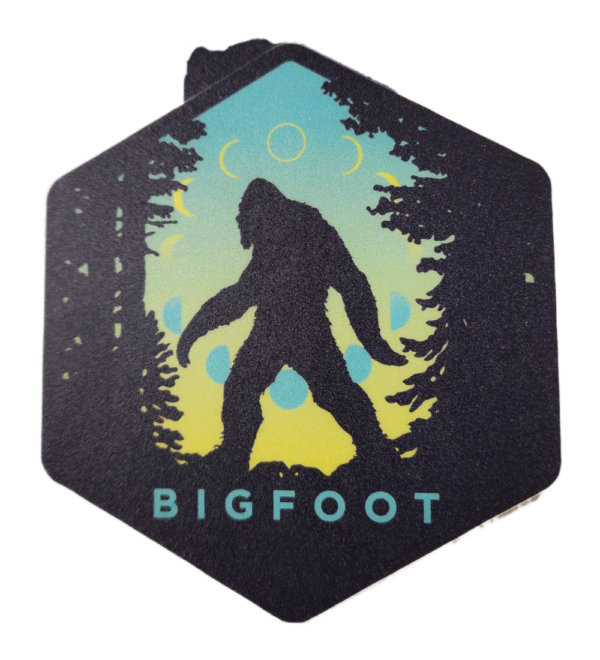 A sticker of a bigfoot in the woods.