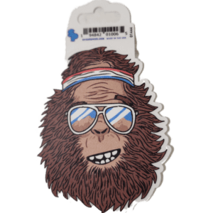 A sticker of a monkey wearing sunglasses and a hat.