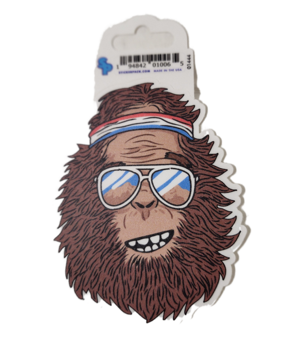 A sticker of a monkey wearing sunglasses and a hat.