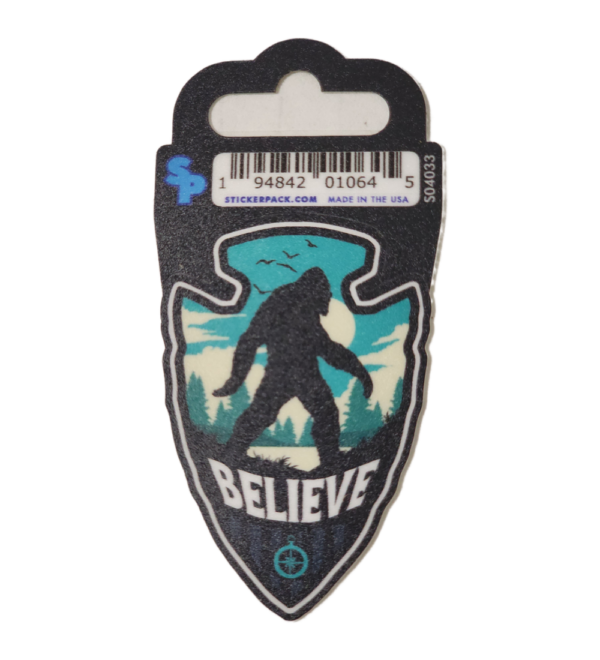 A sticker of a bigfoot with the word believe underneath it.