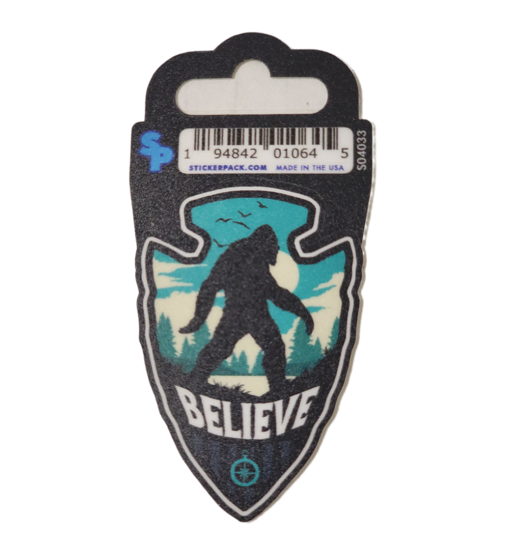 A sticker of a bigfoot with the word believe underneath it.