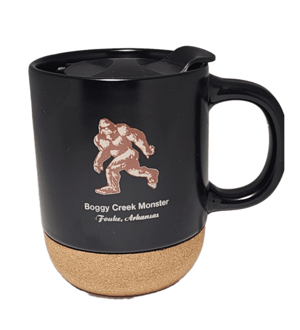 A black mug with a picture of a bigfoot on it.