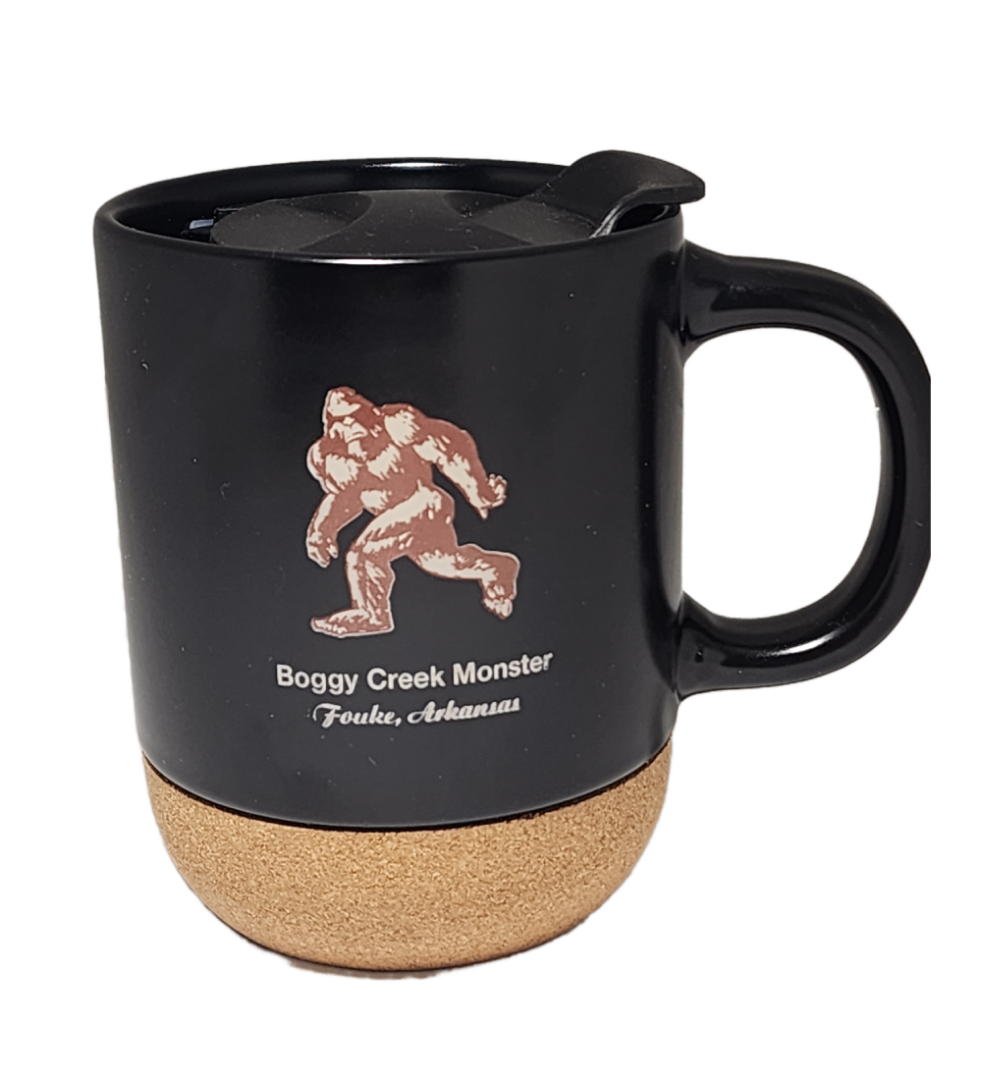 A black mug with a picture of a bigfoot on it.