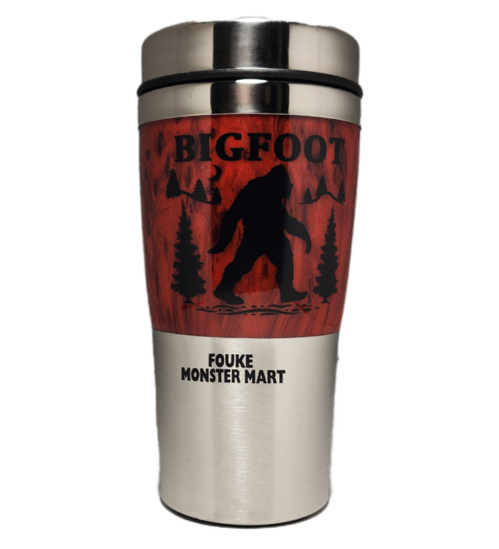 A stainless steel travel mug with a picture of bigfoot on it.