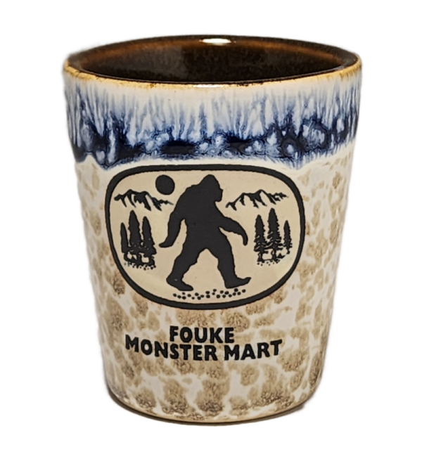 A cup with a picture of bigfoot on it.