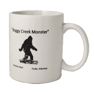 A white coffee mug with an image of a bigfoot.