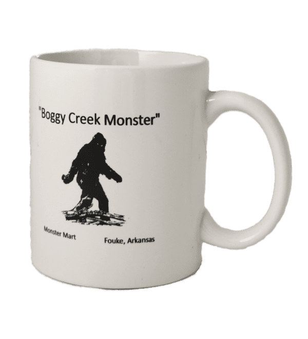 A white coffee mug with an image of a bigfoot.