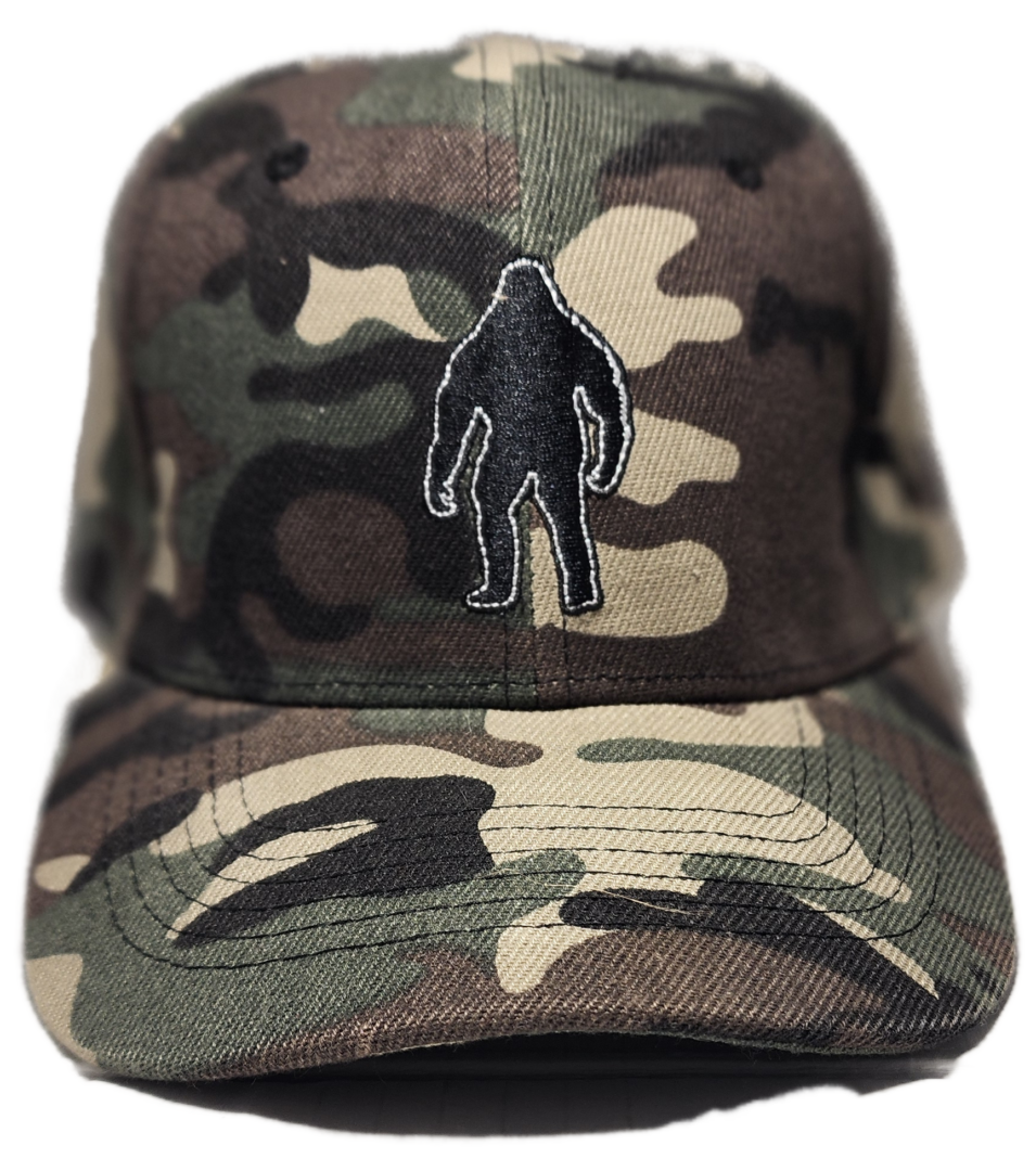 A baseball cap with a bigfoot patch on it.