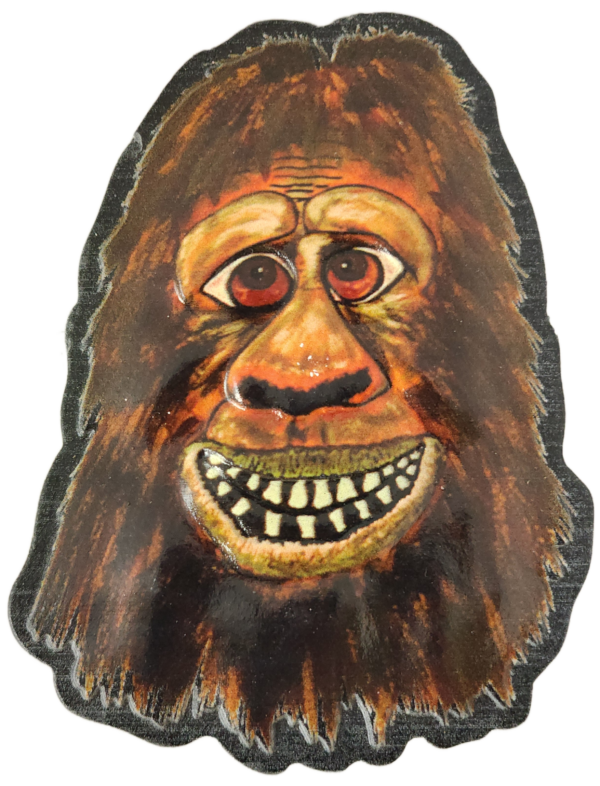 A painting of a bigfoot mask with teeth.