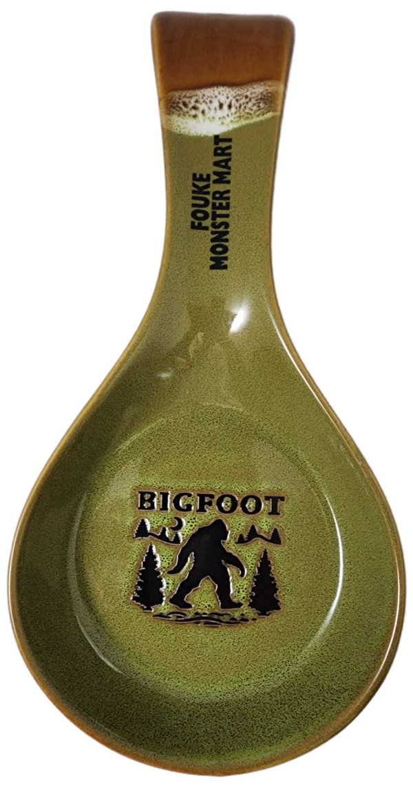 A spoon rest with bigfoot and trees on it.