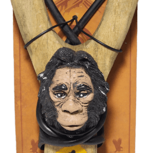 A wooden carving of an ape head hanging from a rope.