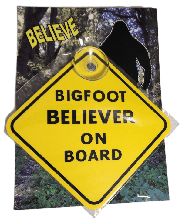 A yellow sign that says bigfoot believer on board.