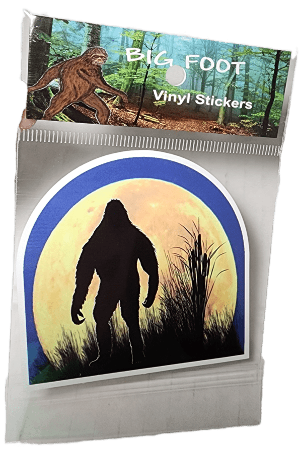 A sticker of a bigfoot in front of the moon.