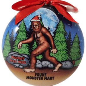 A christmas ornament with a picture of bigfoot.