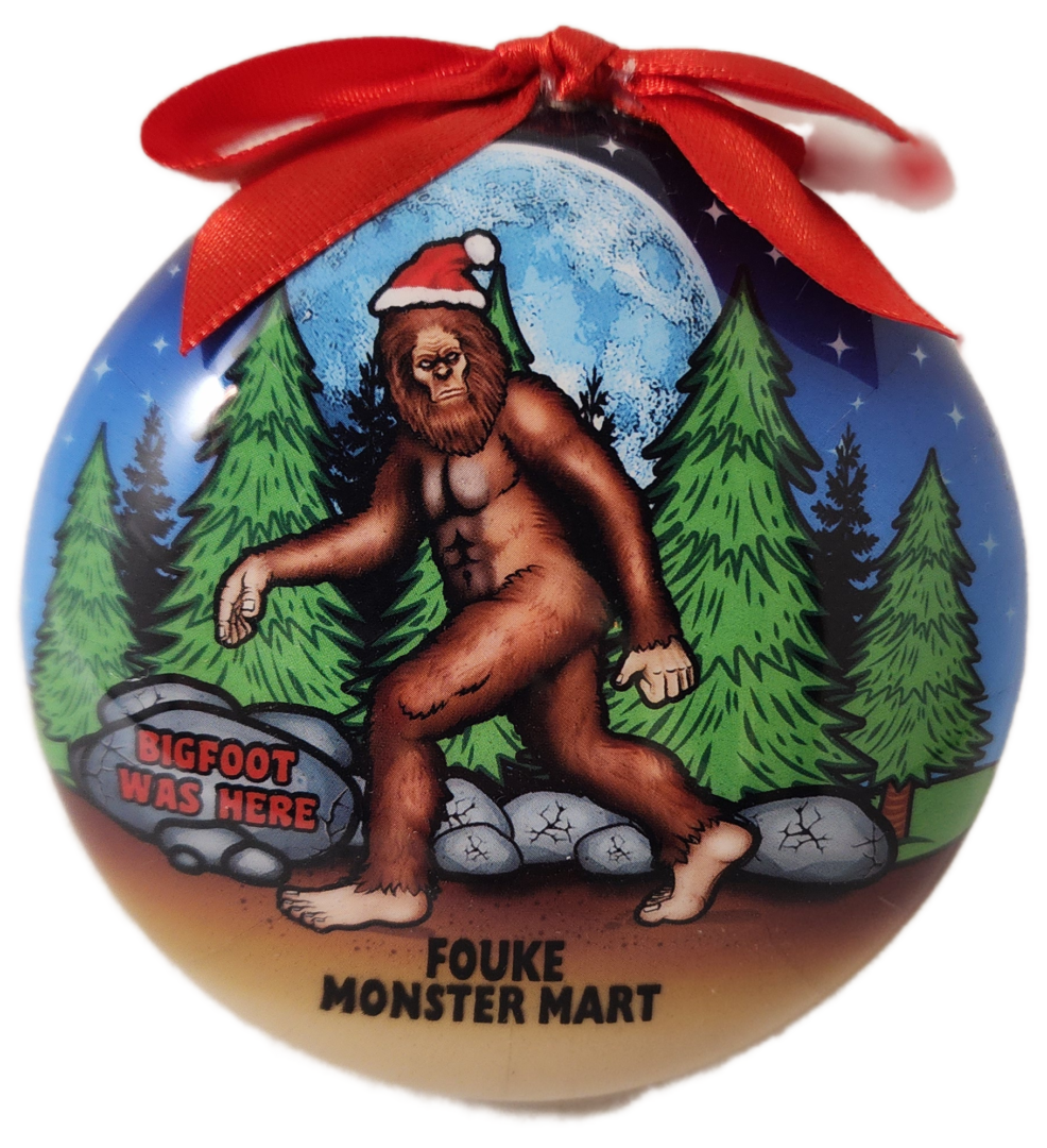 A christmas ornament with a picture of bigfoot.