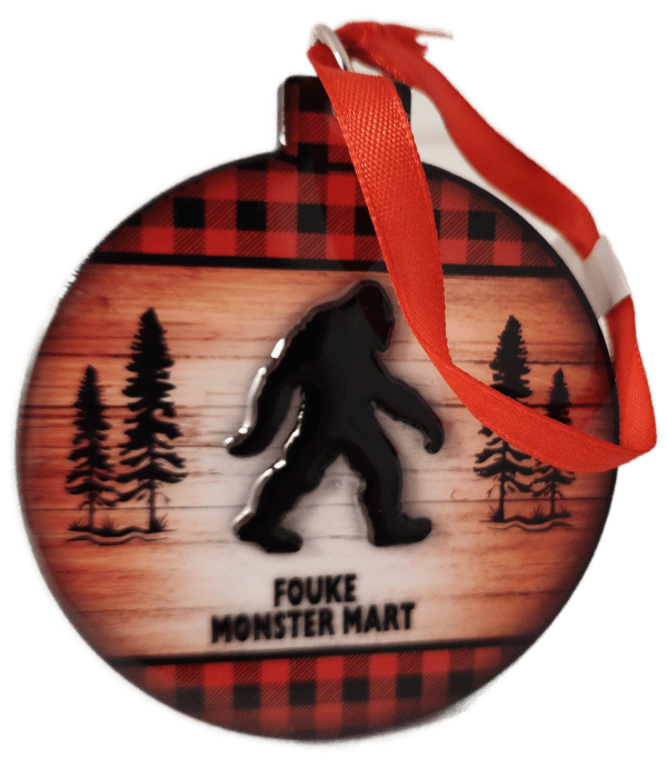 A christmas ornament with the silhouette of a bigfoot.