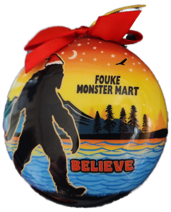 A christmas ornament with a picture of bigfoot.