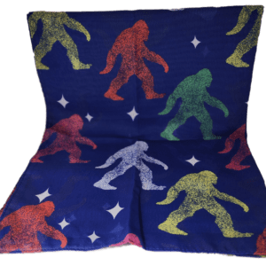 A pillow with colorful bigfoot print on it.