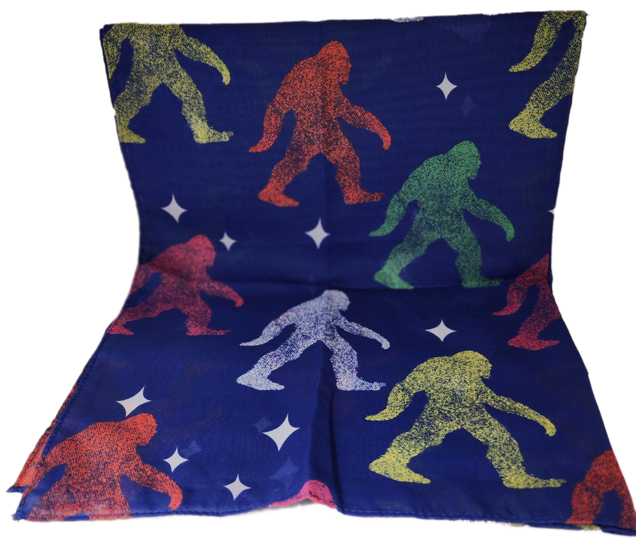 A pillow with colorful bigfoot print on it.