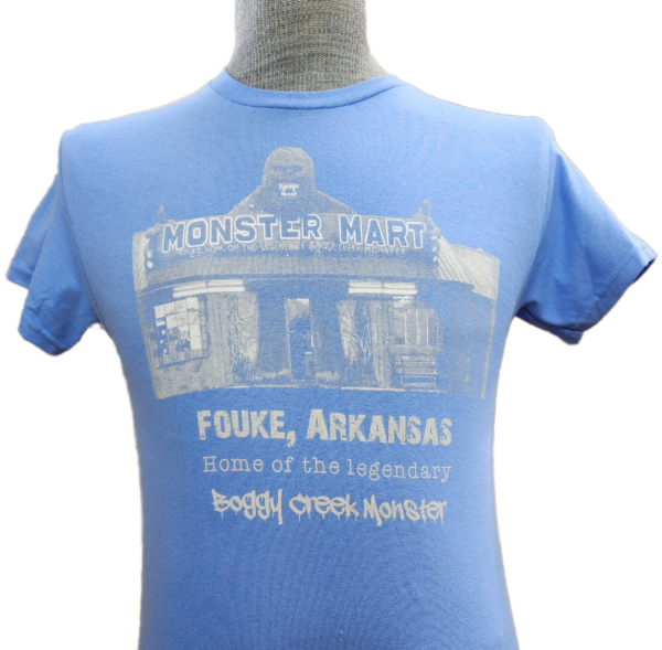 A blue t-shirt with the words " fouke, arkansas " printed on it.