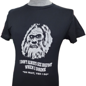 A t-shirt with an old man 's face and the words " don 't always see bigfoot when i drink ".