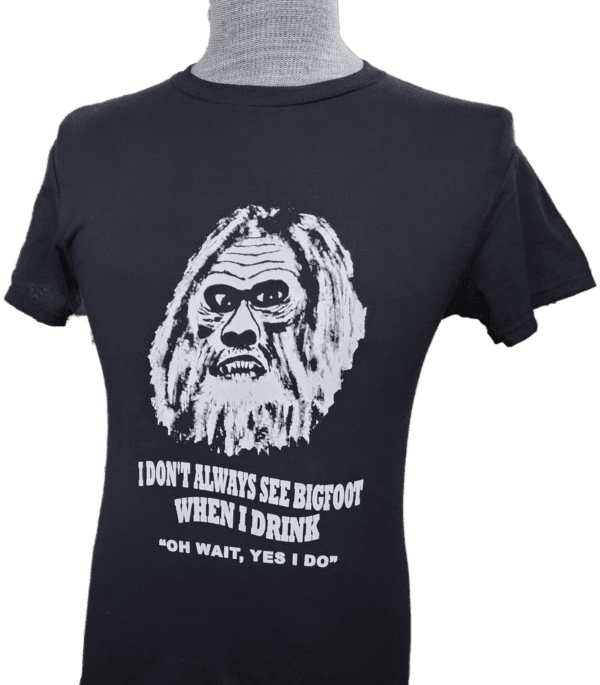 A t-shirt with an old man 's face and the words " don 't always see bigfoot when i drink ".