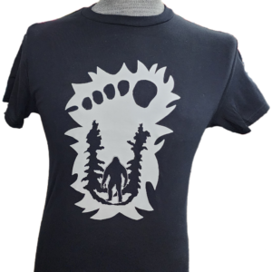 A t-shirt with a bear and trees on it.