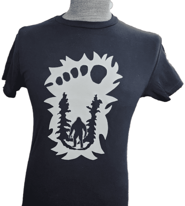 A t-shirt with a bear and trees on it.