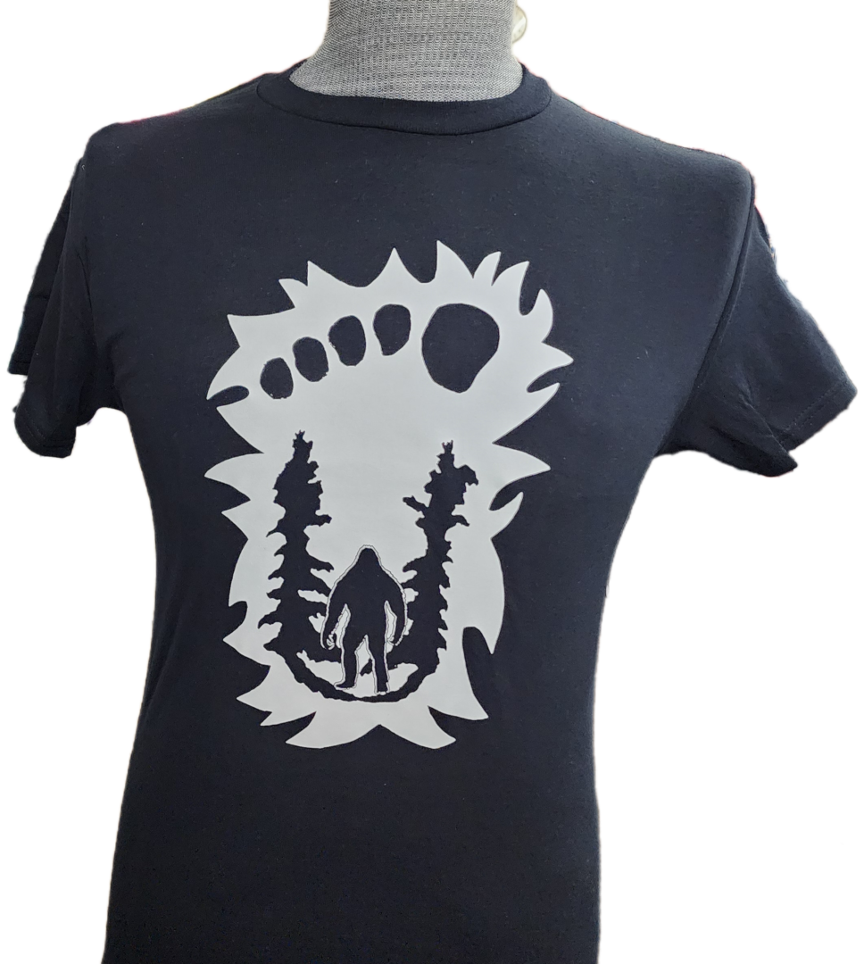 A t-shirt with a bear and trees on it.