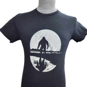 A t-shirt with an image of a man standing on the beach.