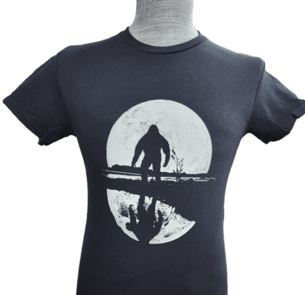 A t-shirt with an image of a man standing on the beach.