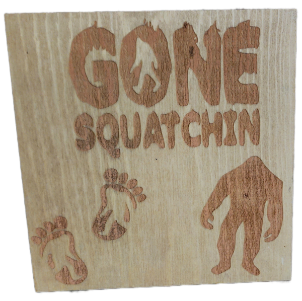 A wooden sign with the words gone squatchin written on it.