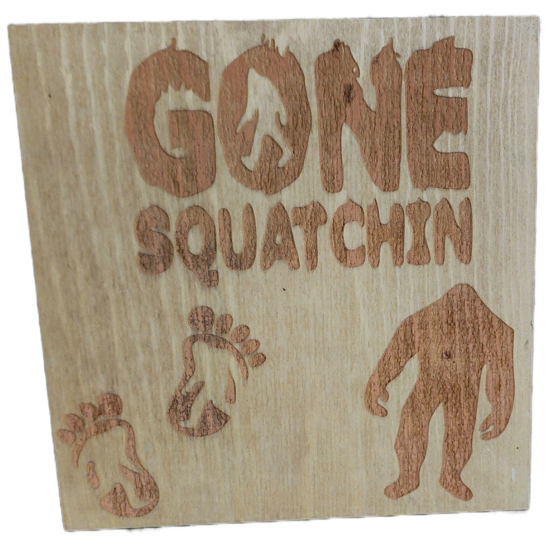 A wooden sign with the words gone squatchin written on it.