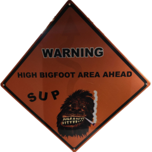 A warning sign with an image of a bigfoot.