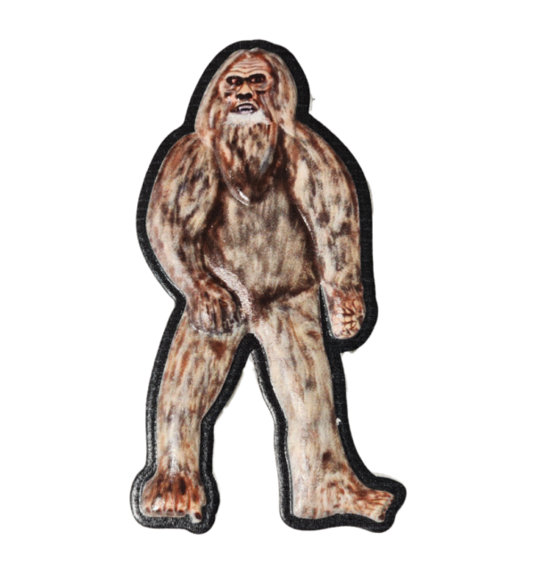 A stuffed animal of a bigfoot is standing.