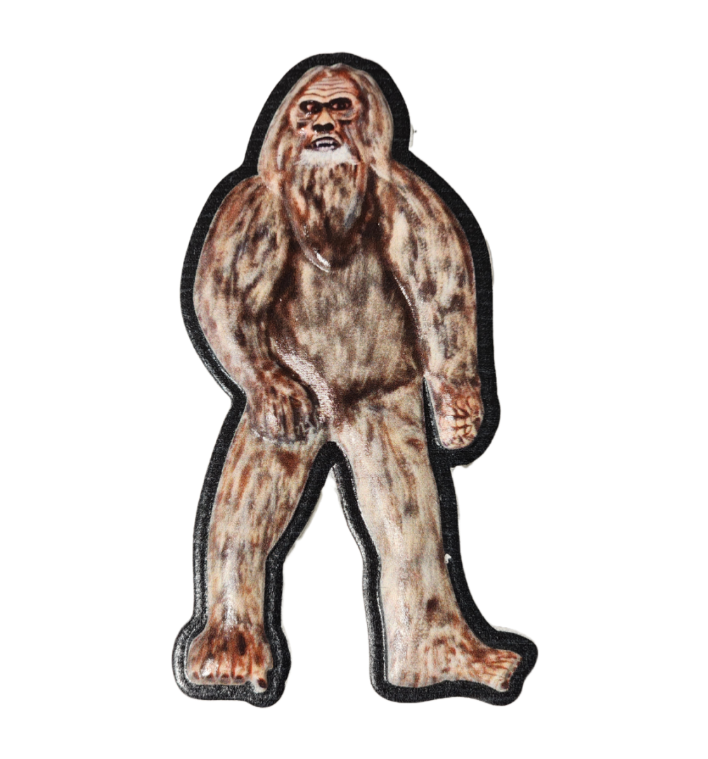 A stuffed animal of a bigfoot is standing.