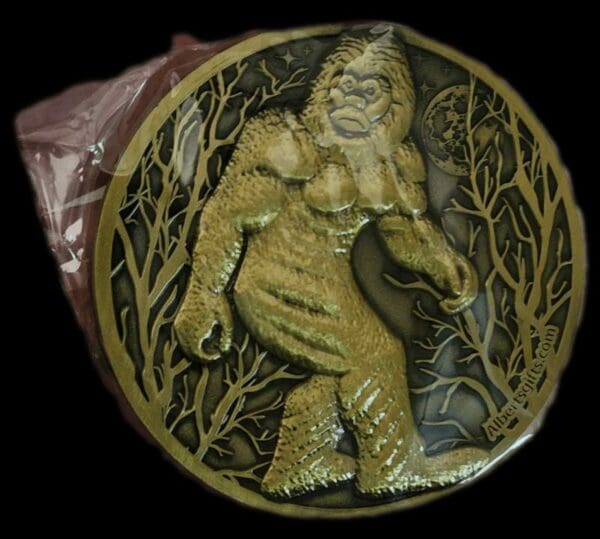 A gold medal with a picture of a bigfoot.