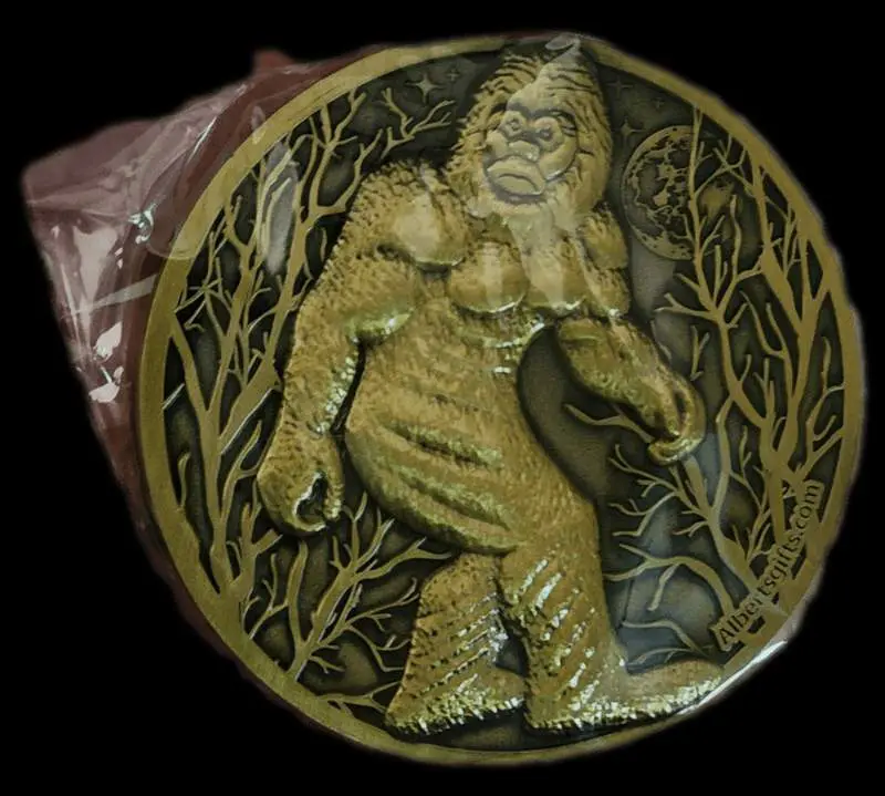 A gold medal with a picture of a bigfoot.