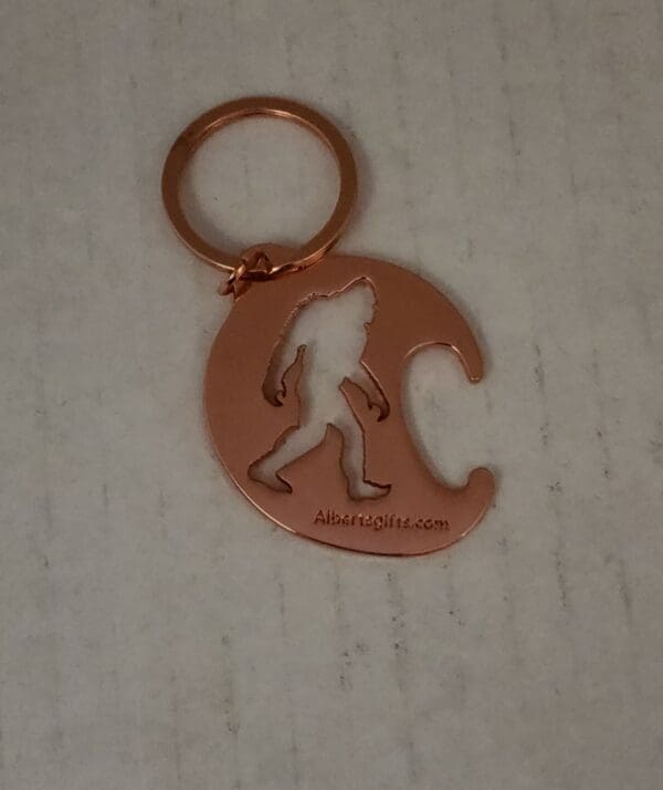 A keychain with the silhouette of a person walking on it.